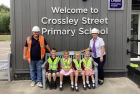 Taylor Wimpey Senior Site Manager Ian Goodwin and Sales Executive Emma Hawkhead with pupils from Crossley Street Primary School