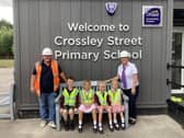 Taylor Wimpey Senior Site Manager Ian Goodwin and Sales Executive Emma Hawkhead with pupils from Crossley Street Primary School