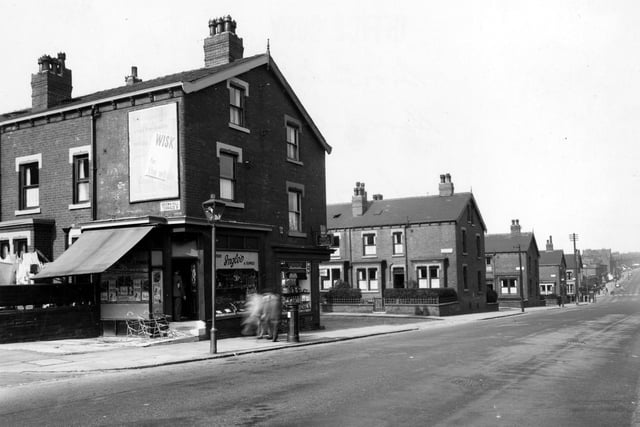 Harehills Lane in September 1949. In focus is 'H. Ingle, Fruit and Flowers', 358 is 'P. Littlehales Grocers'. Further down the road are Sutherland Terrace and Mount, and Compton Row and Crescent. An advertisement for 'Wisk Washing Products' can be seen. On the pavement a lamppost, pillar box and pedestrians are visible.