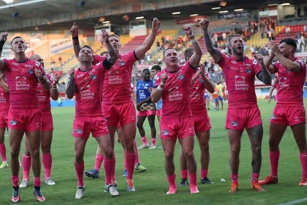 Hardaker - second from right - and teammates celebrate in front of their travelling fans after the win at Catalans. Picture by Manuel Blondeau/SWpix.com.