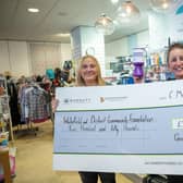 B&DWYW - SGB-28403 -Jenna from Barratt and David Wilson Homes (L) handing Lisa of Wakefield & District Community Foundation