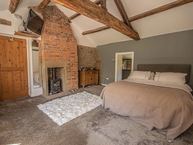 A real warmth to this spacious yet cosy beamed bedroom within the property.