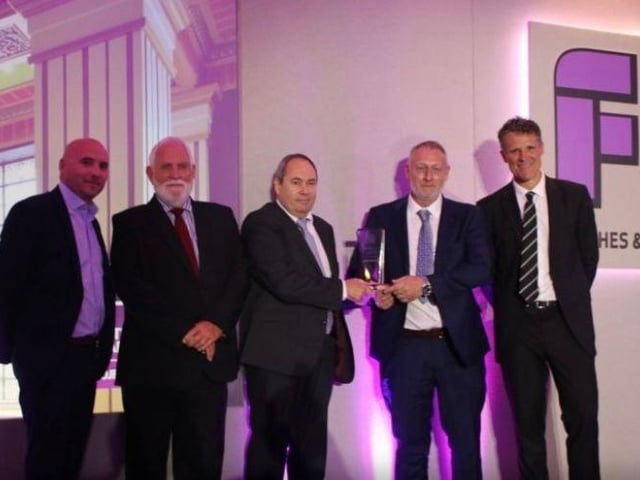Ronnie Clifford and Jim Dodd accepting the award from James Cracknell