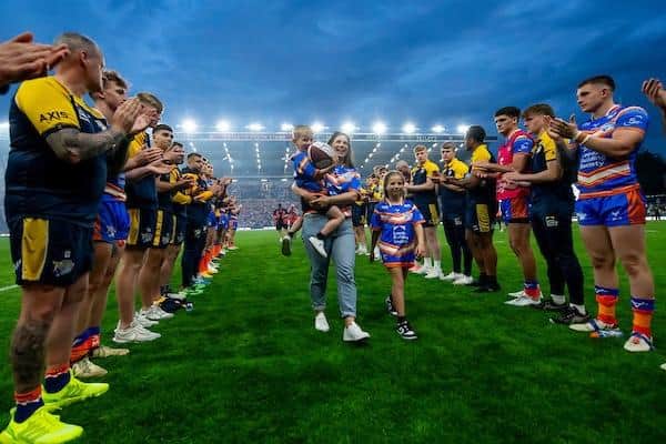 Leeds Rhinos players give Rob Burrow's wife Lindsey, their son Jackson and younger daughter Maya a guard of honour as they leave the field following last week's win against Leigh which was dedicated to the former scrum-half. Picture by Allan McKenzie/SWpix.com.