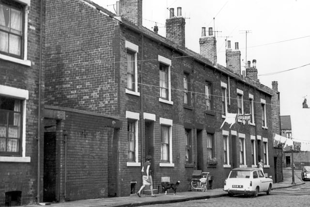 A view along Herbert Street to Servia Grove in July 1967. An Austin A40 countryman car is parked near number 17, there is also a babies pram outside.
