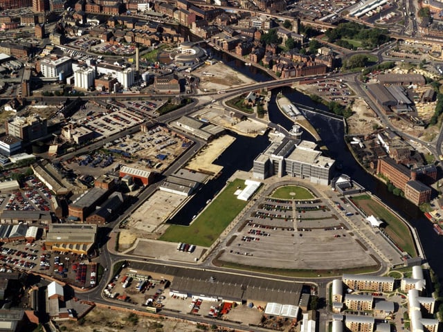 An aerial view from October 1996 showing the River Aire running from centre left to bottom right. Clarence Dock and the recently opened Royal Armouries Museum can be seen in the centre.