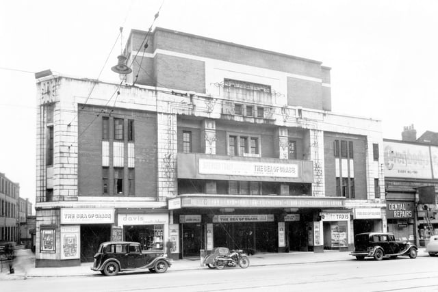 The Ritz Cinema on Vicar Lane pictured in May 1947. It opened in 1934 and changed its name to ABC in 1959. Later the Cannon Cinema. 'The Sea of Grass' is showing and there are clear preview pictures of Katherine Hepburn and Spencer Tracey. There are cars parked outside along with a motor cycle and side car. Davis tobacconists, Ritz Taxis and a Dental Repair premises can be seen.