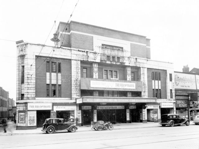 The Ritz Cinema on Vicar Lane pictured in May 1947. It opened in 1934 and changed its name to ABC in 1959. Later the Cannon Cinema. 'The Sea of Grass' is showing and there are clear preview pictures of Katherine Hepburn and Spencer Tracey. There are cars parked outside along with a motor cycle and side car. Davis tobacconists, Ritz Taxis and a Dental Repair premises can be seen.