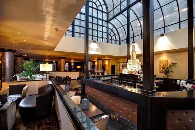 Light fantastic Atrium Bar & Restaurant beckons as President Hotel's beating heart.