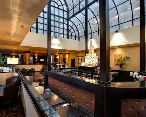 Light fantastic Atrium Bar & Restaurant beckons as President Hotel's beating heart.
