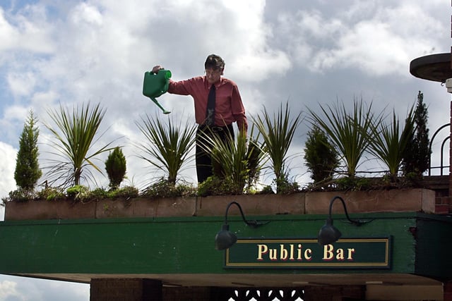 Manager Dave Sim attending to some of the plants at The Broadway pub on Dewsbury Road in May 2002.