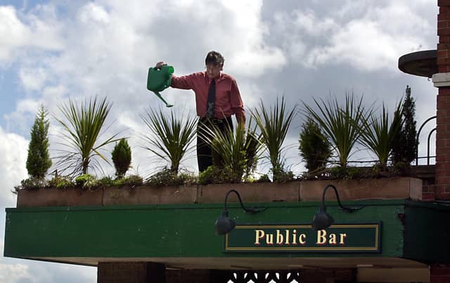 Manager Dave Sim attending to some of the plants at The Broadway pub on Dewsbury Road in May 2002.