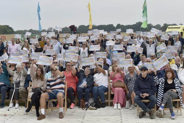 Postcode Lottery winners at Soldiers Field, Roundhay Park with their cheques. (Pic: Steve Riding)