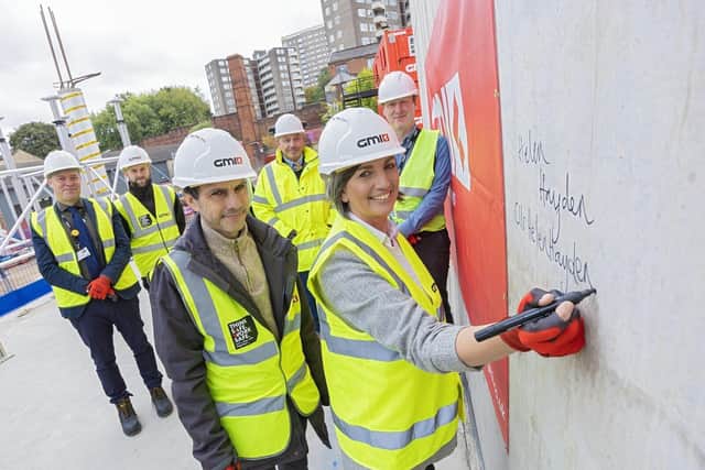 Alex Sobel MP and Cllr Helen Hayden sign concrete work during their tour of the Mabgate site.