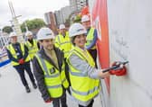 Alex Sobel MP and Cllr Helen Hayden sign concrete work during their tour of the Mabgate site.
