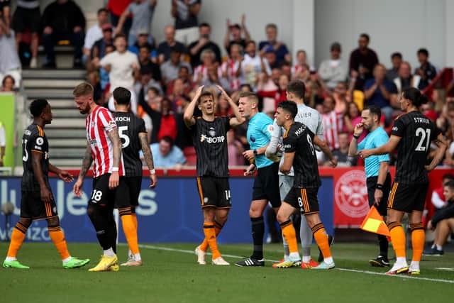 BEES' STING: Leeds United's Diego Llorente, centre, shows his frustration as Brentford are awarded a penalty en route to a 5-2 sinking of the Whites. 
Photo by Steve Bardens/Getty Images.