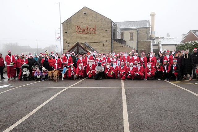 The Drighlington Dynamos Santas pose for a group picture outside the main sponsor, Prashad
