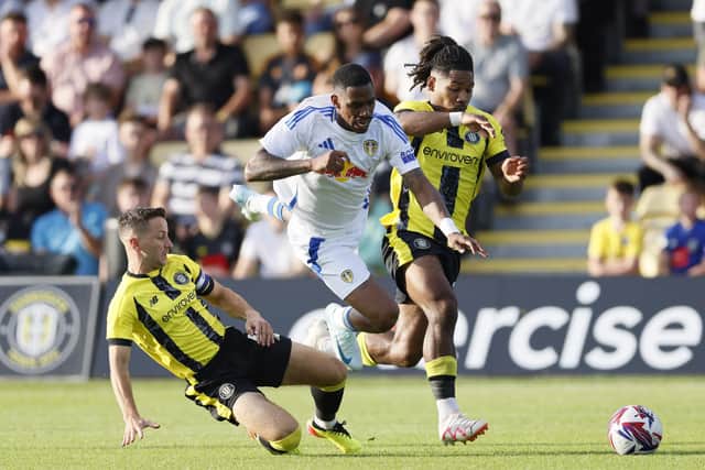 ON THE CHARGE Leeds United's Junior Firpo battles Harrogate Town's Matthew Foulds and Zico Asare during Friday evening's pre-season friendly. Photo by Richard Sellers/PA Wire.