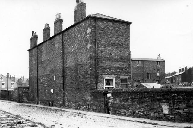 The rear of Vicar Street pictured in August 1964. Both are three storey blind back properties with large gardens. The road is weed ridden cobbles and in the distance on the left is the site of the Tower Table Water Co. Ltd.