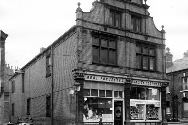 The impressive brick built industrial Co-operative Society Buildings at the at the junction of Malvern Road with Cross Kiln Street.  Decorative detailing was an important feature and the elaborate shape is achieved with ordinary bricks. Victorians were found of this type of brickwork. Fronting on to Malvern Road is the L. I. C. S. meat purveyors with with the butcher seen through the window with a customer. Next door is 'Quality Footwear' and beyond far right is Broadway Terrace.