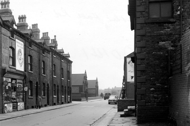 Hunslet Hall Road in May 1955. The corners of Disraeli Terrace and Mariners Road are visible. R. Terrill's tobacconists and an advertisement for Hovis bread is visible on the left.