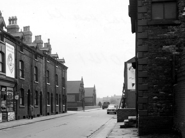 Hunslet Hall Road in May 1955. The corners of Disraeli Terrace and Mariners Road are visible. R. Terrill's tobacconists and an advertisement for Hovis bread is visible on the left.