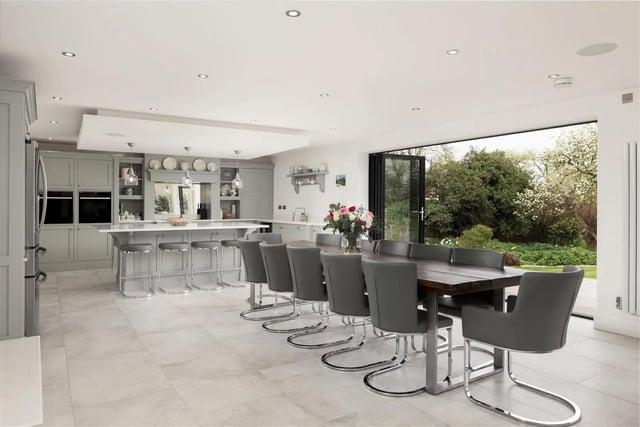 The entrance of the property leads through to a show stopping open plan kitchen, perfect for entertaining. It includes top-of-the-range kitchen features and the room opens out onto the west facing garden through two sets of bi folding doors.