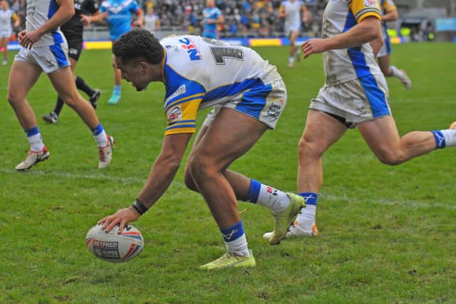 Derrell Olpherts scores the second of his two tries in Rhinos' Boxing Day win against Wakefield. Picture by Steve Riding.