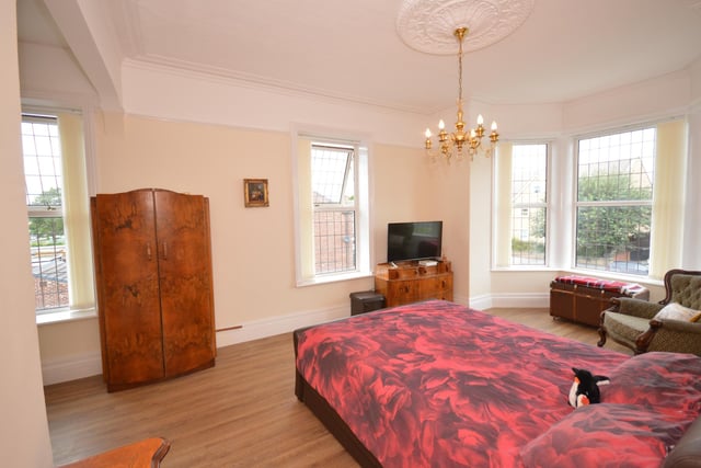 This double bedroom benefits from natural light from several large windows.