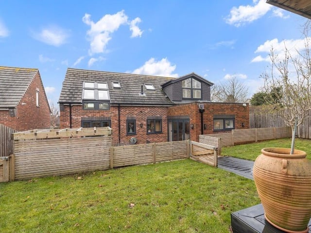Externally, the property has a large landscaped garden with established planting, lawned areas and seating spaces.