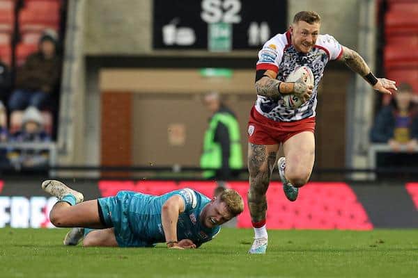 Josh Charnley breaks away from Rhinos' James McDonnell. Picture by Paul Currie/SWpix.com.