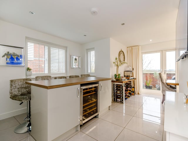 The breakfast bar is a feature of the stylish kitchen.