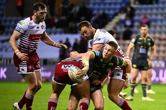 Harry Newman is tackled during Leeds Rhinos' defeat at Wigan Warriors in May. Picture by Olly Hassell/SWpix.com.