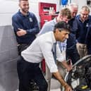 Rishi Sunak chats with technicians during an inspection of the workshop facilities