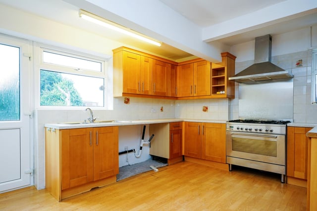 The ground floor kitchen benefits from clean decor that leaves plenty of room for renovation. There is also a dining space on the ground floor.