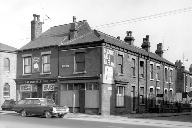 Two properties on Low Road stand to the left of this view, Car Disposals at number 29 selling spare parts and tyres and an empty shop at number 29a. Balcombe Grove runs to the right in ascending order from number 1 on the left. Included in slum clearance plans for the Hunslet area. Pictured in March 1968.
