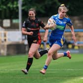 Evie Cousins makes a break for Leeds Rhinos in the Betfred Women's Super League clash with St Helens at AMT Headingley. Picture by Alex Whitehead/SWpix.com.