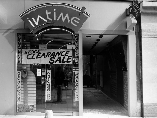 Intime Jewellers on Lands Lane in April 1989. Posters advertise a stock clearance sale with watches at half price. A passageway on the right leads to the back of the shop.