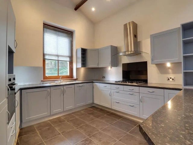 The kitchen is located to the front aspect and while open plan, achieves a feeling of being separate to the main living space.