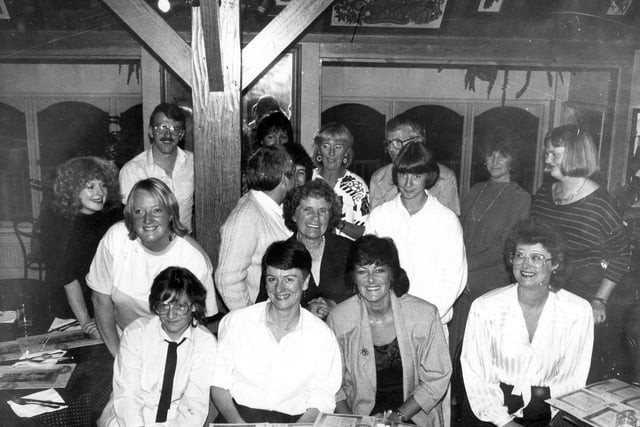 A group portrait of staff and local residents of Alston Lane centre on the occasion of a farewell party for the central organiser, Faye White, seen in the centre. She had worked as the central organiser for four years but prior to that she had five years experience as a schools social worker attached to Seacroft Park, Foxwood and Parklands Schools. She had also spent four years with the Family Service Unit in Seacroft. Pictured in November 1987.