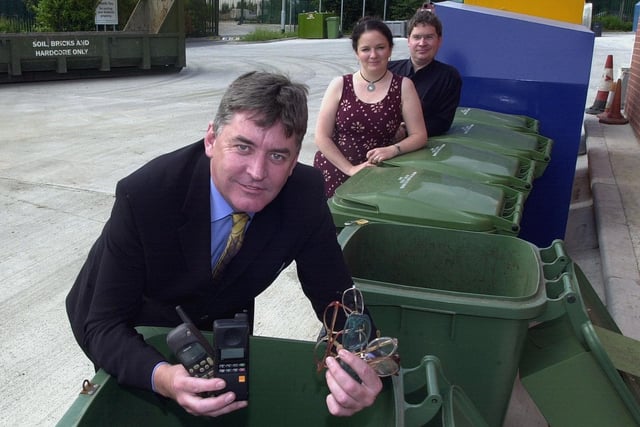 Coun Gerry Harper inspects facilities for recycling mobile phones and glaases at the newly-reopened household waste recycling centre on Holmewell Road in July 2003. Looking on are Coun Stuart Bruce (Middleton ward) and Coun Karen Marshall, lead member for City Services.