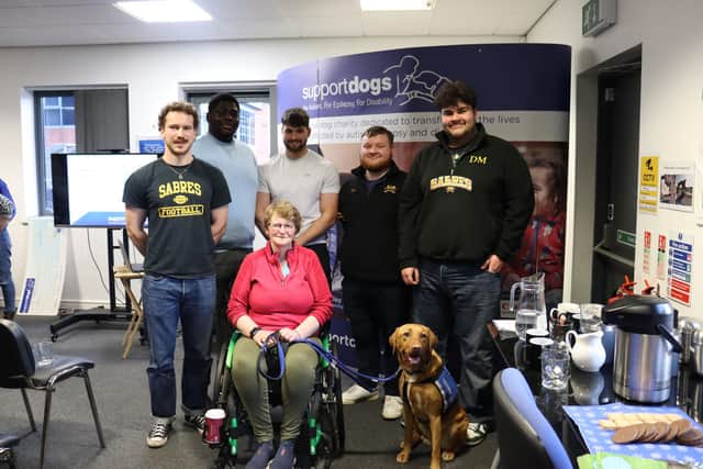 Amanda Davidson and her support dog Chris with members of Sheffield Sabres (left to right) Will Robertson, Tosin Akintola, Henry Veary, Thomas Glover and Danny Mullick.