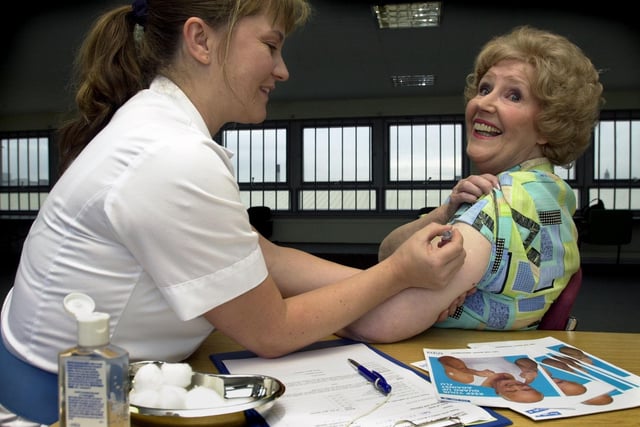 Staff nurse Rosie Evans gives Emmerdale actress Paula Tilbrook, who played Betty Eagleton, a flu jab at the soap's Kirkstall Road studios.