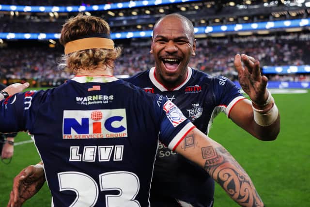 Maika Sivo and Danny Levi celebrate Leeds Rhinos' 58-6 victory over Hull KR in Las Vegas. Picture by Alex Whitehead/SWpix.com.
