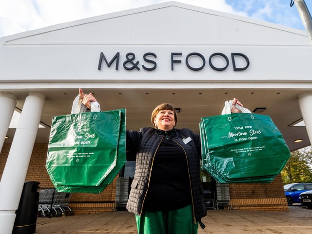 Celia Driver, a customer assistant, welcoming people into the store