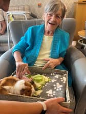 Resident from HC-One’s April Park Care Home with guinea pigs from Leanimals Petting Zoo