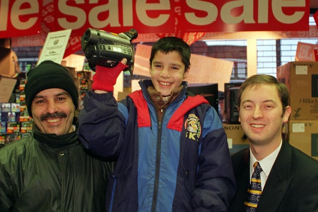 Asar Khan, a mature student studying at Bradford University, with his young son Zeeshan queued since Christmas Eve afternoon at the Sony Centre to be first in the queue for the Boxing Day sales in December 1997. Manager David Smith was so impressed with their commitment  that he gave them the video camera that they had been waiting for.