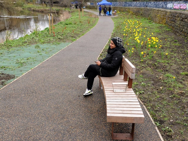 A footpath weaves through the middle of the park, with public seating areas also dotted along the route.
