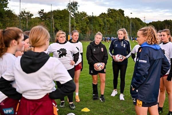 Rhinos' England duo Georgia Roche and Caitlin Beevers, plus Leeds coach Lois Forsell, pass on tips to Dewsbury Moor players during the Three Lions Week session at Kirkstall. Picture by Will Palmer/SWpix.com