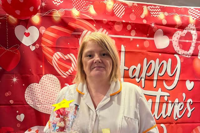 Colleague with raffle prize and tickets at Augustus Court Care Home